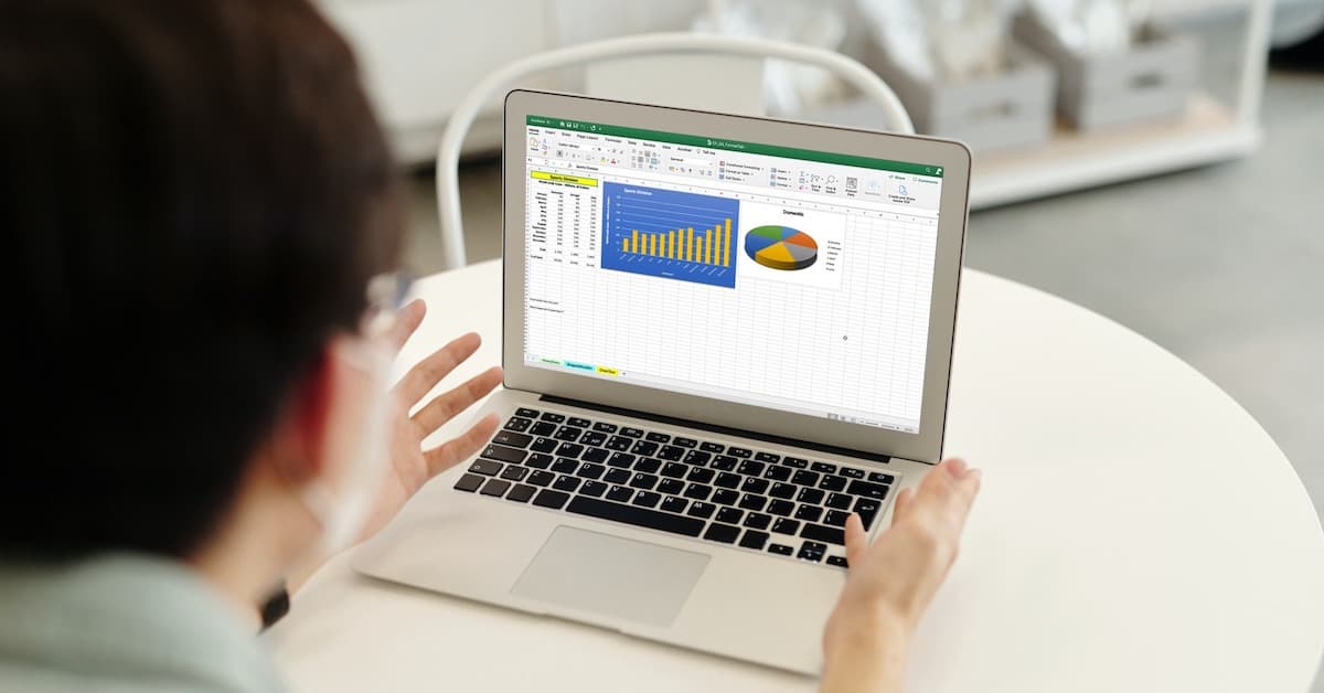 User on a MacBook with Excel charts displayed