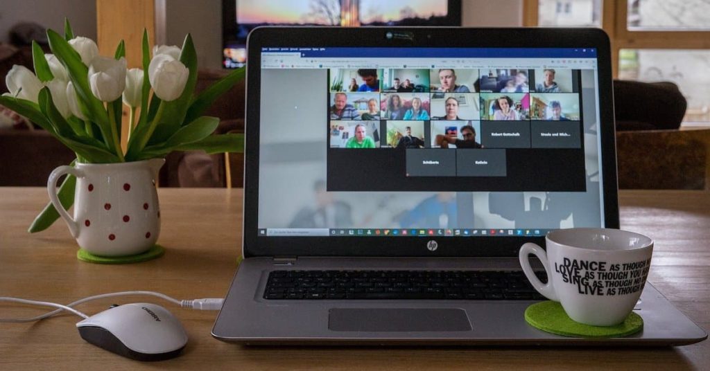 HP laptop showing users in an online Zoom meeting